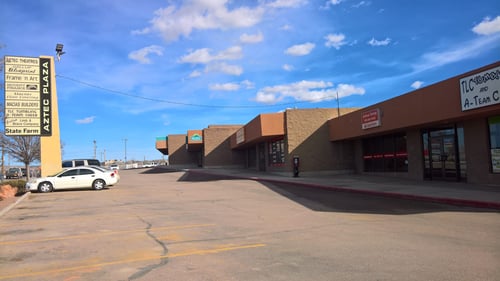 Brown office building with red State Farm sign