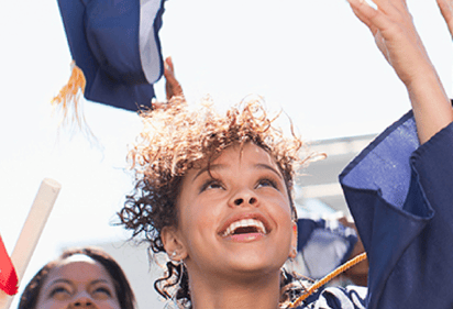 college grad tossing cap in the air