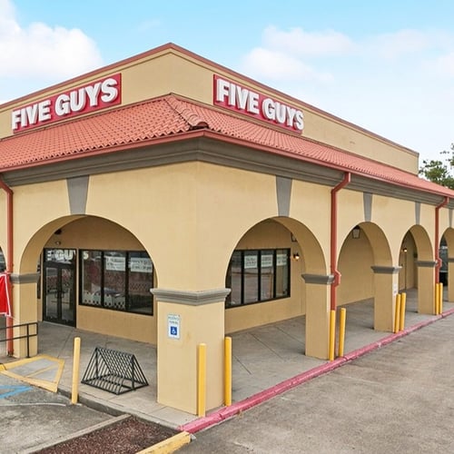 Exterior photograph of the Five Guys restaurant at 5300 Tchoupitoulas Street in New Orleans Louisiana.