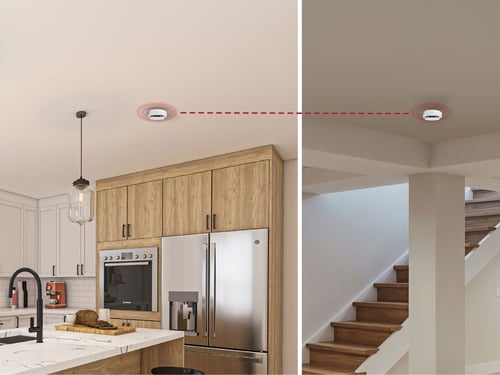 A split image of two rooms, showing a smoke alarm going off in both, with a dotted line connecting them.