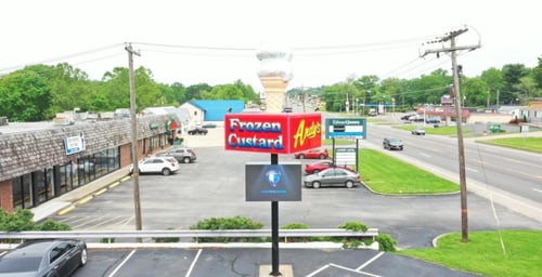 frozen custard sign with a digital sign below showing company logo