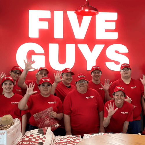 Employees pose for a photograph ahead of the grand opening of the Five Guys restaurant in Grand Junction Colorado.