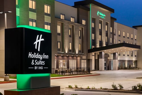 Holiday Inn Suites Commerce City Denver Airport signage at dusk.