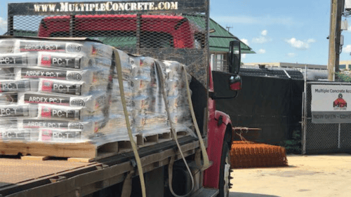 truck with large pallet of concrete on it