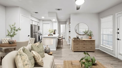 a living room with a couch a coffee table and a dining table  at Carmel at Deerfield, San Antonio