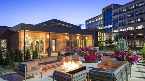 a patio with couches and a fire pit in front of a building at Pearl DTC, Colorado