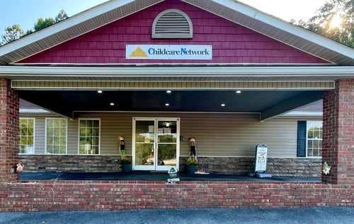 Front view of the school building with a welcoming entrance, designed to create a safe and friendly environment for children and families.