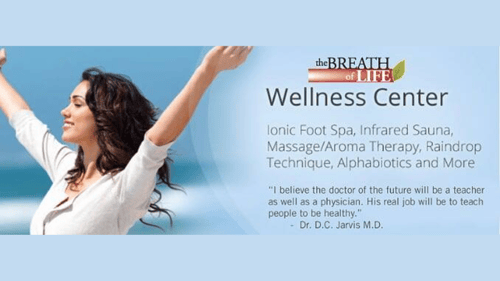 woman outside holding her hands up next to the business logo