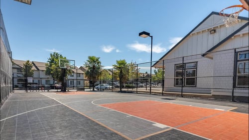 A basketball court with a basketball hoop and a basketball net at Stoneplace Apartment Homes, Molalla