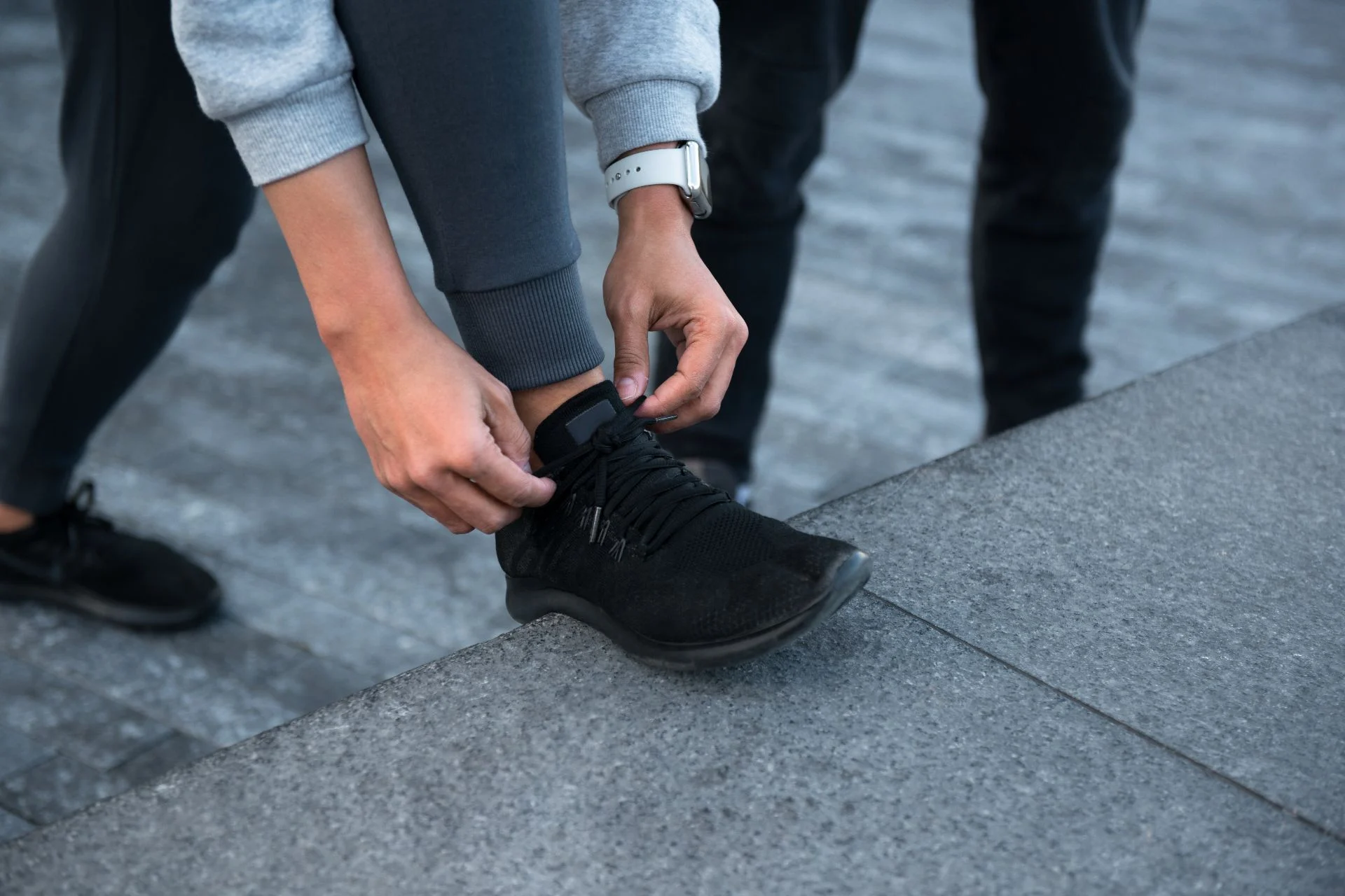 person lacing up shoes best for standing all day