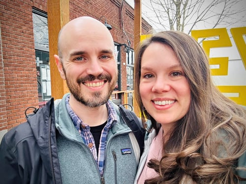 Agent Jacquline standing and smiling with husband outside celebrating anniversary