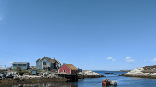 Coastal community showcasing Canadian heritage with traditional waterfront buildings and calm harbour.