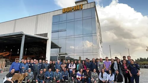 Domat Concrete Machinery employee group photo taken outside of office building