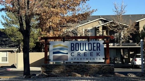 A sign for Boulder Creek Apartments is in front of a building at Boulder Creek Apartments in Sun Valley, NV, 89433