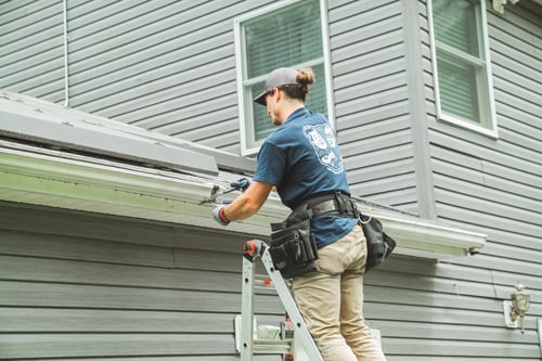 gutter technician repairing gutter