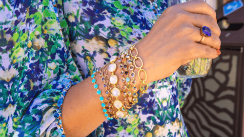 womans arm with various artisan bracelets on