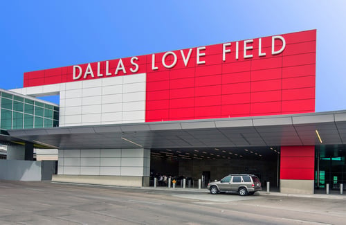 Dallas Love Field Airport exterior with red architectural wall panels and modern commercial façade installation by NOW Specialties.