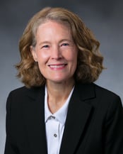 Shanna Case, MD smiling in front of a cool gray background.