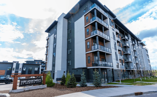 Apartment building at Vibe Apartments at Arbour Lake in Calgary, AB