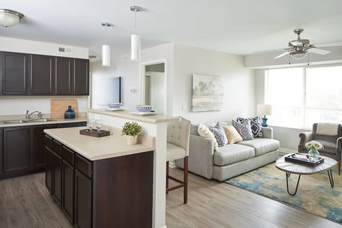 a living room and kitchen with a couch and a table at Meadowlark Place Apartments, Iowa, 50111