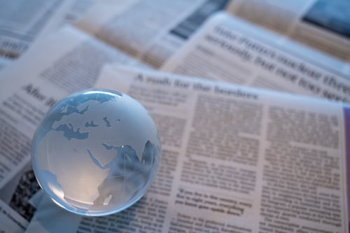 a glass globe sitting on a newspaper