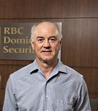 Larry Mumford posing in front of the RBC DS sign