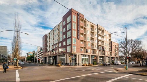 the patterson social apartment building at the corner of an intersection