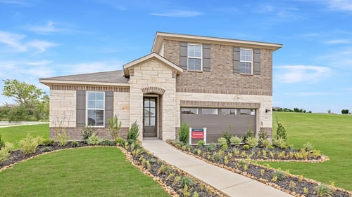 two-story new home with brick exterior and big yard