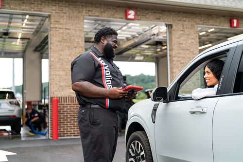 Valvoline technician greets guest on arrival and checks her in.