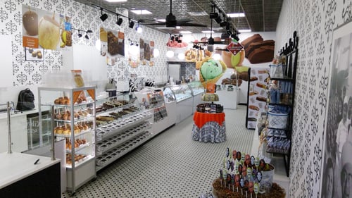Interior of the Kilwins Cumming, GA 30041 chocolate, fudge, and ice cream store showing ice cream and fudge cases and unique candy displays