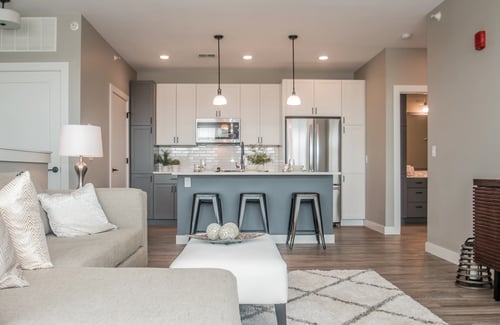 Kitchen and living room open space at Tivoli Green Apartments & Townhomes in Mount Pleasant, WI 53406