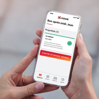 Person holding their phone using the Kidde App