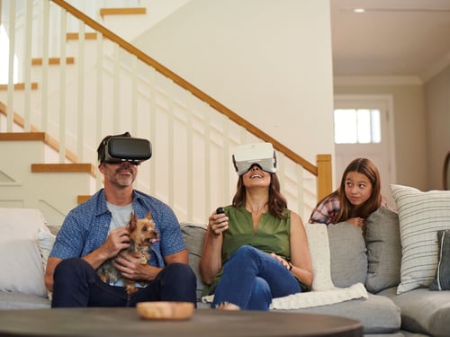 Couple with teenage daughter using fiber internet with VR game