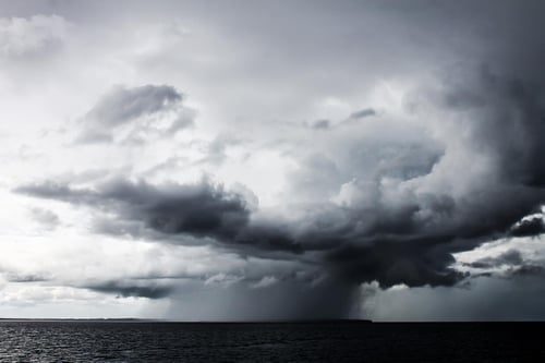Black and white image of storm clouds over the ocean