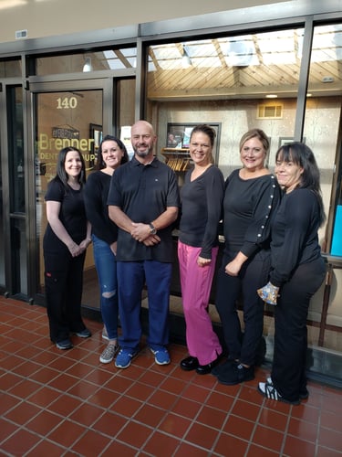 Team members of Brenner Dental Group of Southampton PA standing in front of their office entrance