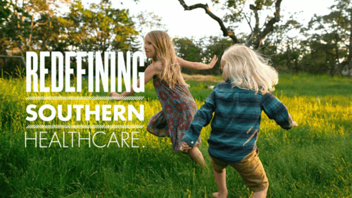 two children running through grass