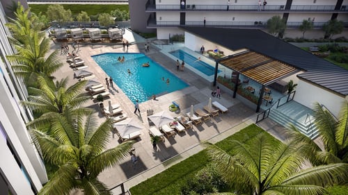 Resort style pool with hot tub, lounge chairs with umbrellas on a spacious sundeck.