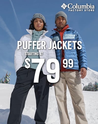 man and woman wearing puffer jackets in snow