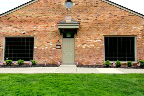 Brick building with olive green door