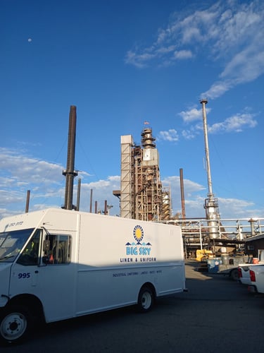 Big Sky Linen & Uniform service truck delivering industrial uniforms and linen services at a Montana industrial facility
