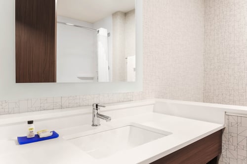 Spacious guest bathrooms with ample counter space.