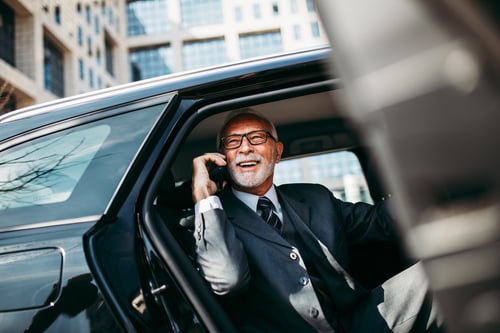business man on the phone in the car