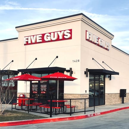 Exterior photograph of the Five Guys restaurant at 1428 North Old Decatur Road in Saginaw Texas.