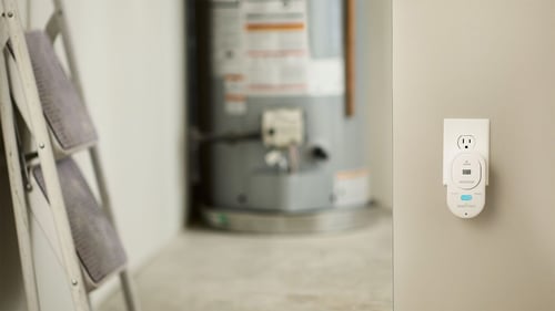 A carbon monoxide alarm is plugged into the wall.