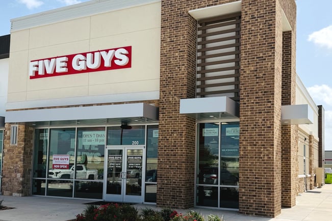 Exterior photograph of the Five Guys restaurant at 11115 West Grand Parkway South in Richmond, Texas.
