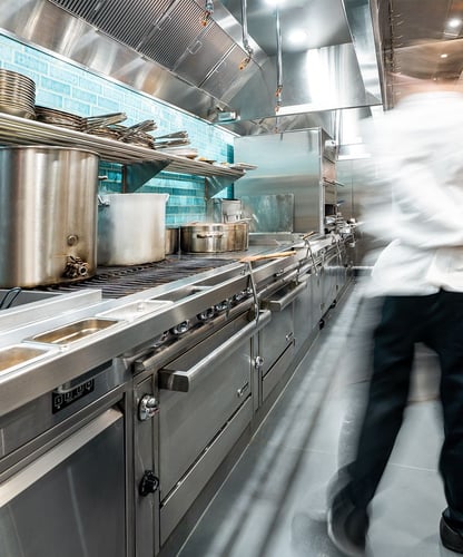 Professional chef working in a high-performance commercial kitchen equipment