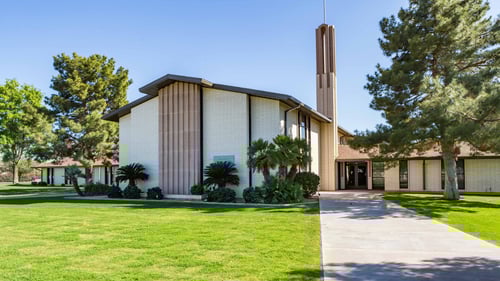 large ranch style white, block, church with spire