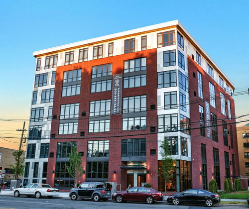 Modern apartment building exterior at sunset at Park Bayonne Apartments, Bayonne