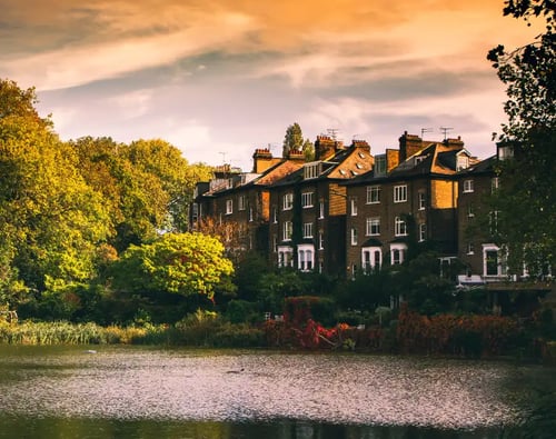Knight Frank Hampstead Estate Agents - Hampstead - Scenic view of lake by buildings against sky during sunset, Hampstead Heath desktop