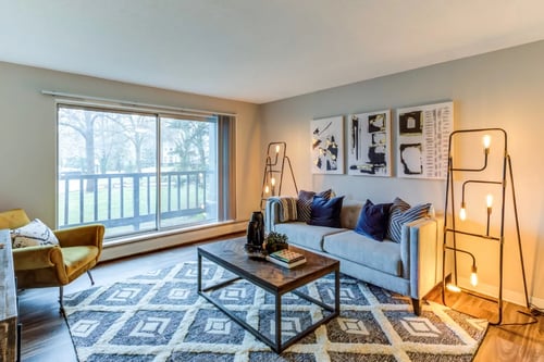 Living Room with Balcony at Audenn Apartments in Bloomington, MN
